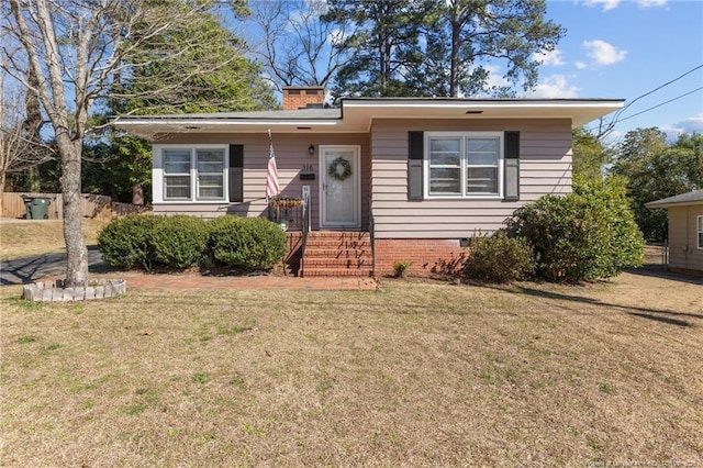 bungalow-style house with crawl space, a chimney, and a front yard