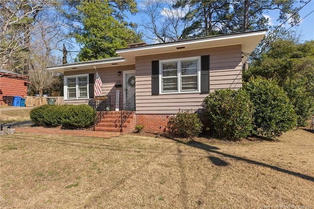 bungalow-style home with a front yard