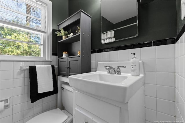 bathroom with curtained shower, vanity, toilet, and tile walls