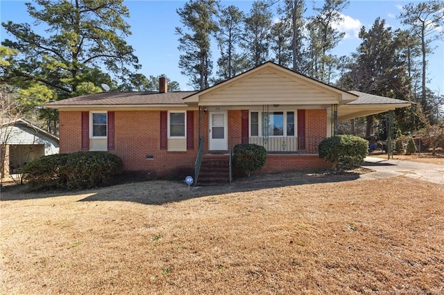 single story home with driveway, brick siding, crawl space, a porch, and a front yard