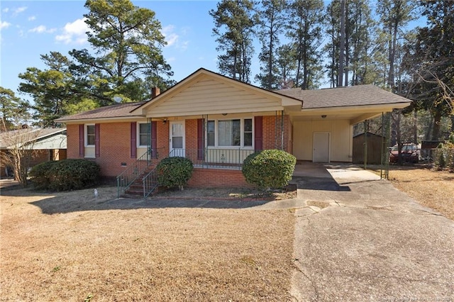 ranch-style home with a carport, a porch, concrete driveway, and brick siding