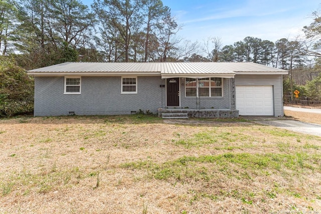 single story home featuring crawl space, a garage, metal roof, and brick siding