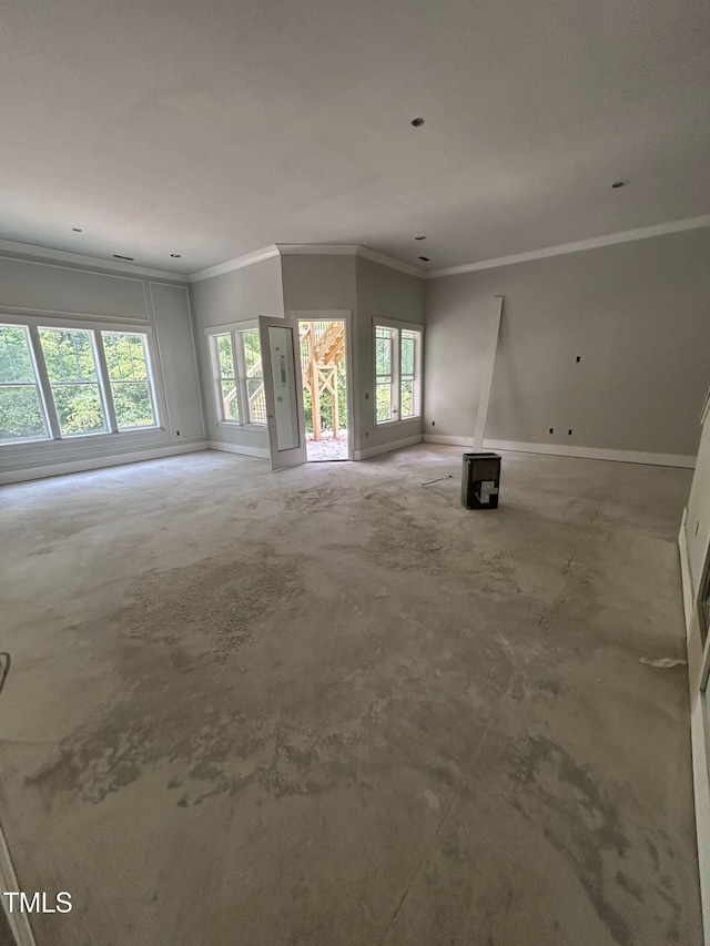 108 Pointe Park Cir, Holly Springs, NC 27540 - unfurnished living room featuring ornamental molding, baseboards, healthy amount of natural light, and unfinished concrete flooring