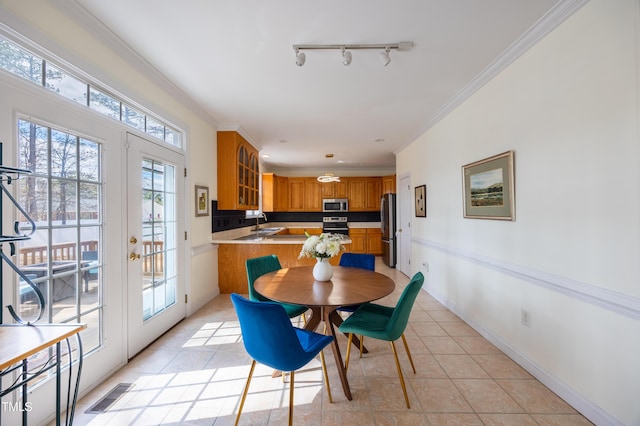 dining area featuring visible vents, baseboards, ornamental molding, french doors, and light tile patterned flooring