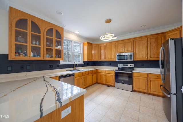 kitchen featuring tasteful backsplash, glass insert cabinets, crown molding, appliances with stainless steel finishes, and a sink