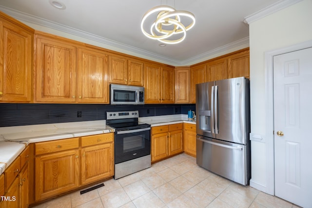 kitchen with visible vents, crown molding, light countertops, brown cabinets, and appliances with stainless steel finishes