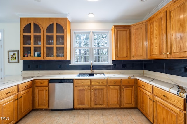 kitchen featuring brown cabinetry, ornamental molding, decorative backsplash, a sink, and dishwasher