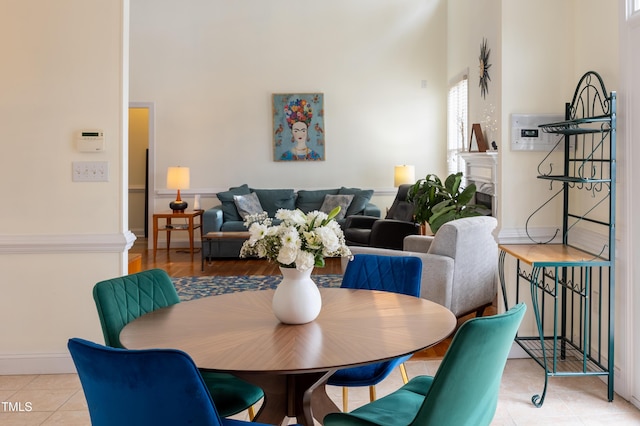 dining area featuring light tile patterned flooring and baseboards