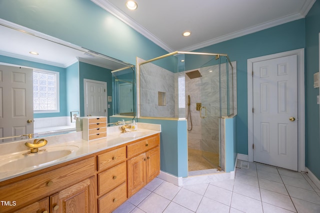 full bathroom with tile patterned floors, ornamental molding, a stall shower, and a sink