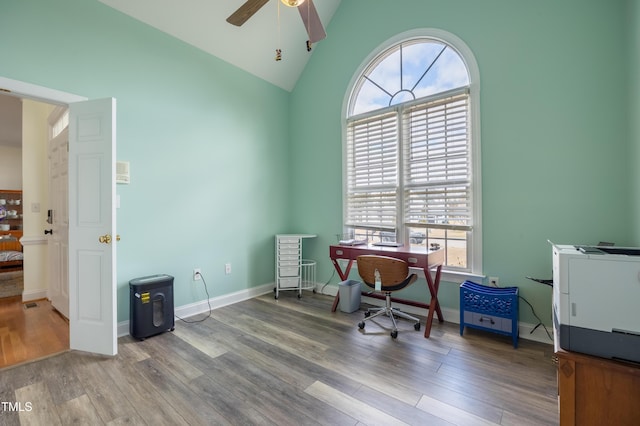 office featuring vaulted ceiling, baseboards, a ceiling fan, and wood finished floors