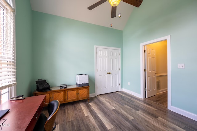 office space with visible vents, dark wood-style floors, baseboards, and high vaulted ceiling