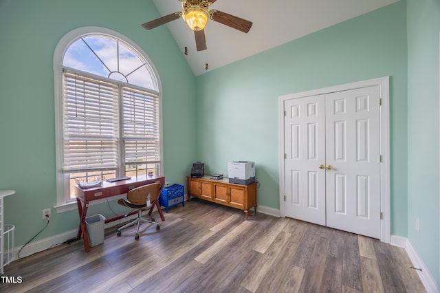 office space with ceiling fan, baseboards, high vaulted ceiling, and wood finished floors