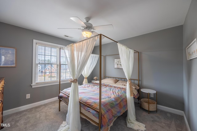 carpeted bedroom featuring a ceiling fan, baseboards, and visible vents