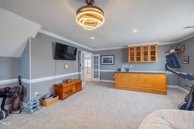 interior space featuring glass insert cabinets, light carpet, baseboards, and ornamental molding