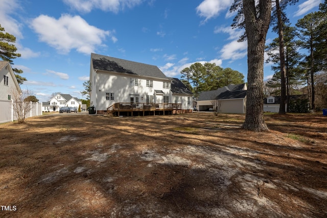 rear view of property with fence, a residential view, and a wooden deck