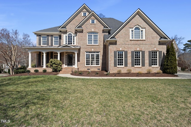 view of front of home featuring brick siding and a front lawn