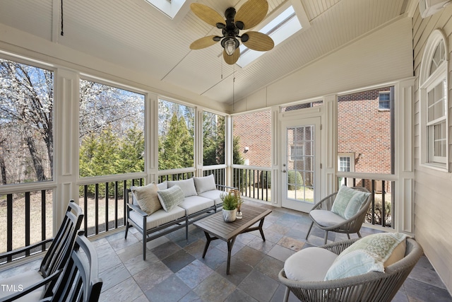 sunroom / solarium featuring lofted ceiling with skylight, ceiling fan, and wooden ceiling