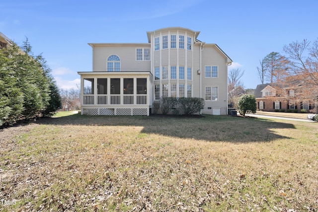 rear view of property featuring a lawn and a sunroom