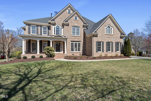 view of front of property featuring brick siding and a front lawn