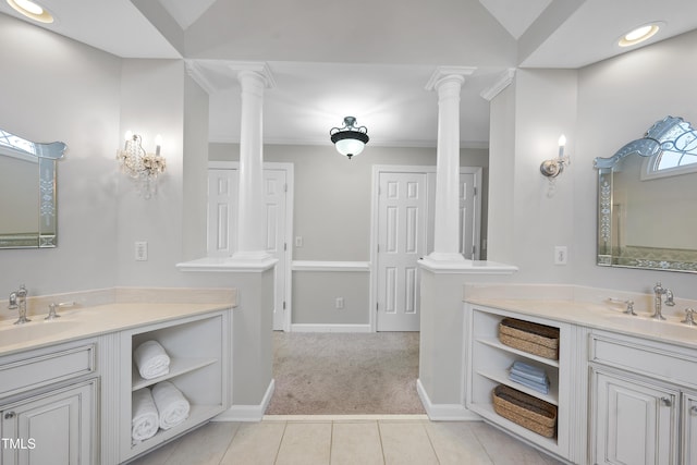 bathroom with two vanities, ornate columns, and a sink