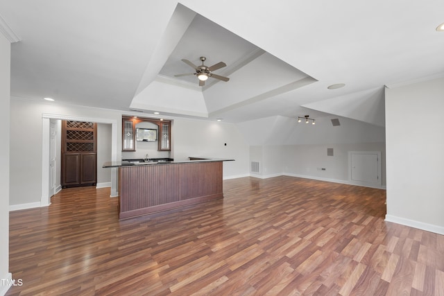 kitchen with visible vents, wood finished floors, dark countertops, and open floor plan