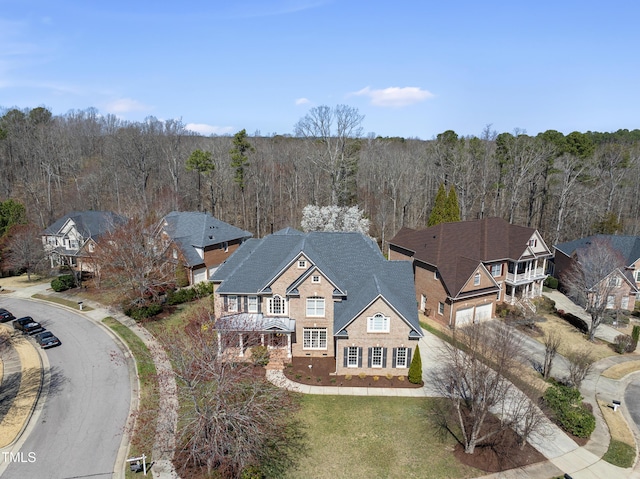 bird's eye view with a wooded view