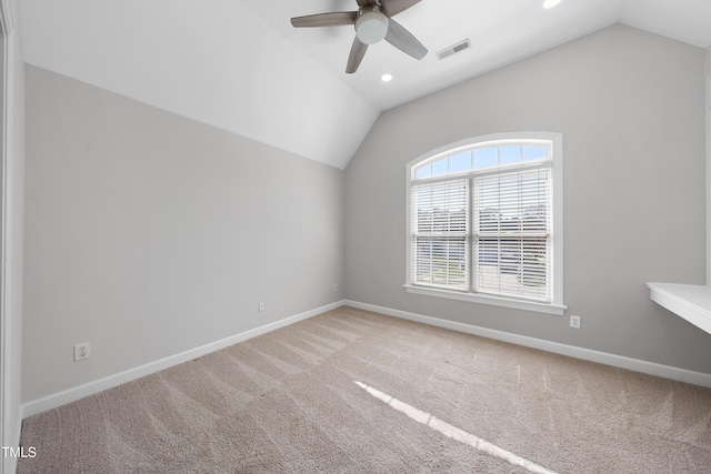 empty room with visible vents, ceiling fan, baseboards, and lofted ceiling