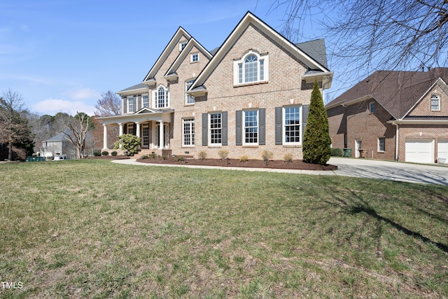 view of front of home featuring brick siding, a porch, and a front yard