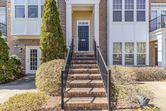 entrance to property featuring brick siding