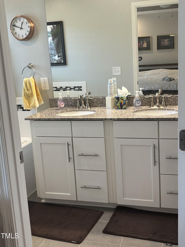 bathroom featuring a sink and double vanity