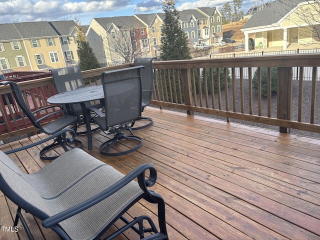 deck featuring a residential view and outdoor dining space