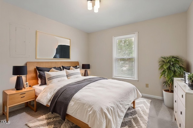 bedroom featuring light colored carpet and baseboards