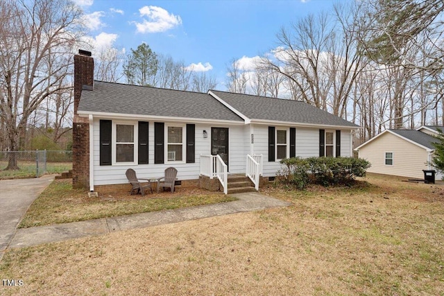 ranch-style house featuring fence, a front yard, a shingled roof, crawl space, and a chimney