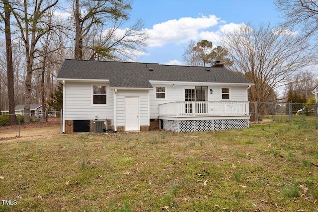 rear view of property with fence, a wooden deck, central AC unit, a chimney, and a yard