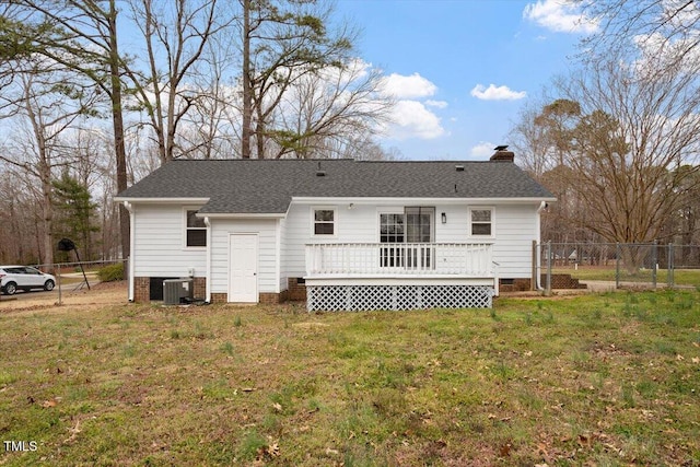 rear view of house featuring crawl space, a lawn, a chimney, and fence