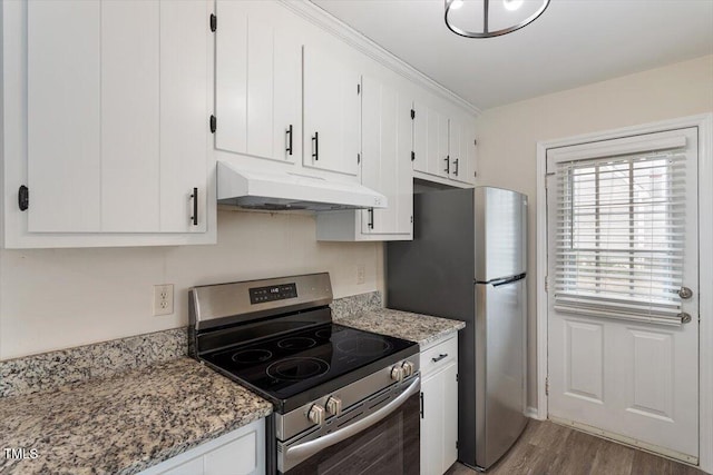 kitchen featuring light stone countertops, wood finished floors, under cabinet range hood, appliances with stainless steel finishes, and white cabinetry