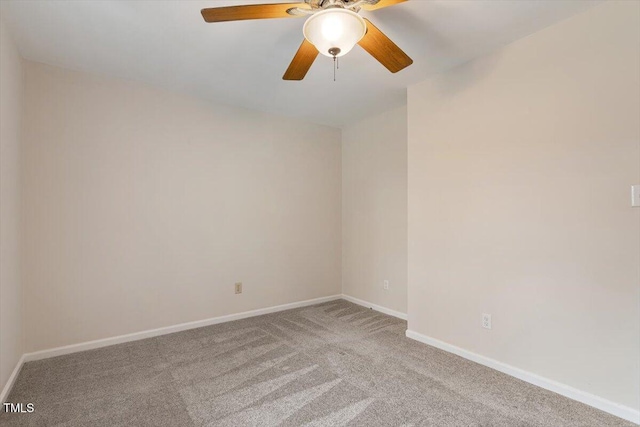 unfurnished room with carpet flooring, a ceiling fan, and baseboards