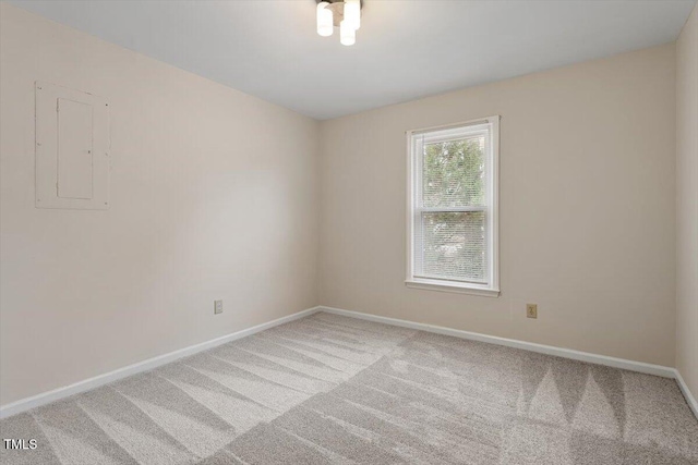 empty room with baseboards and carpet