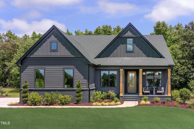 view of front of home featuring roof with shingles, a front lawn, board and batten siding, and a porch