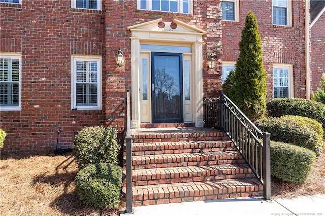 doorway to property with brick siding