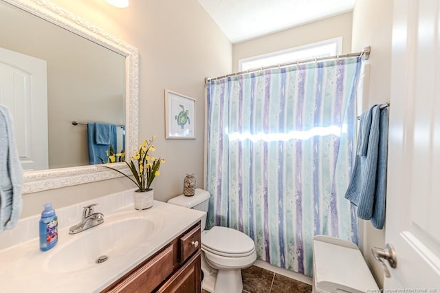 bathroom with toilet, curtained shower, vanity, and tile patterned floors