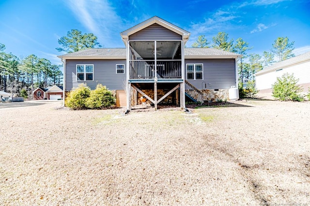 rear view of house featuring stairway and a sunroom