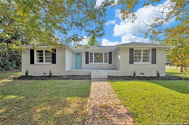 view of front of property with a front yard, crawl space, and brick siding