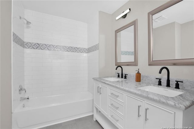 full bathroom featuring double vanity, tile patterned flooring, a sink, and shower / bathtub combination