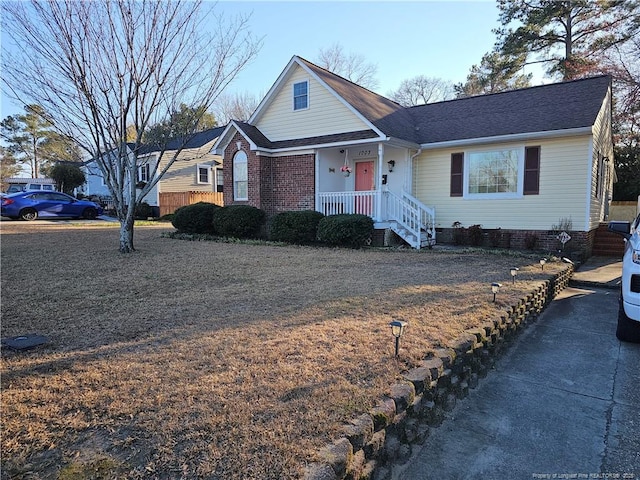 view of front facade featuring crawl space, roof with shingles, and brick siding