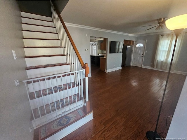 interior space with baseboards, stairs, ornamental molding, and dark wood finished floors