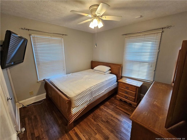 bedroom with ceiling fan, a textured ceiling, baseboards, and dark wood-style flooring