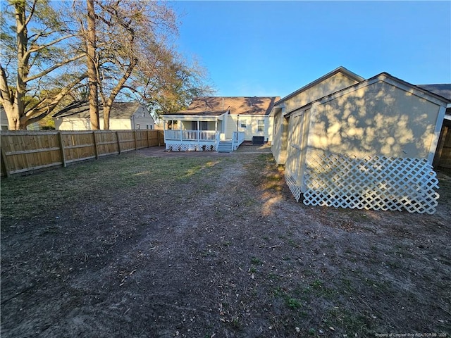 rear view of property with a fenced backyard