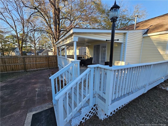 exterior space featuring stairs, fence, a deck, and ceiling fan