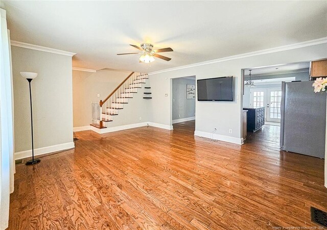 1003 Anarine Rd, Fayetteville, NC 28303 - unfurnished living room with a ceiling fan, crown molding, stairs, wood finished floors, and baseboards